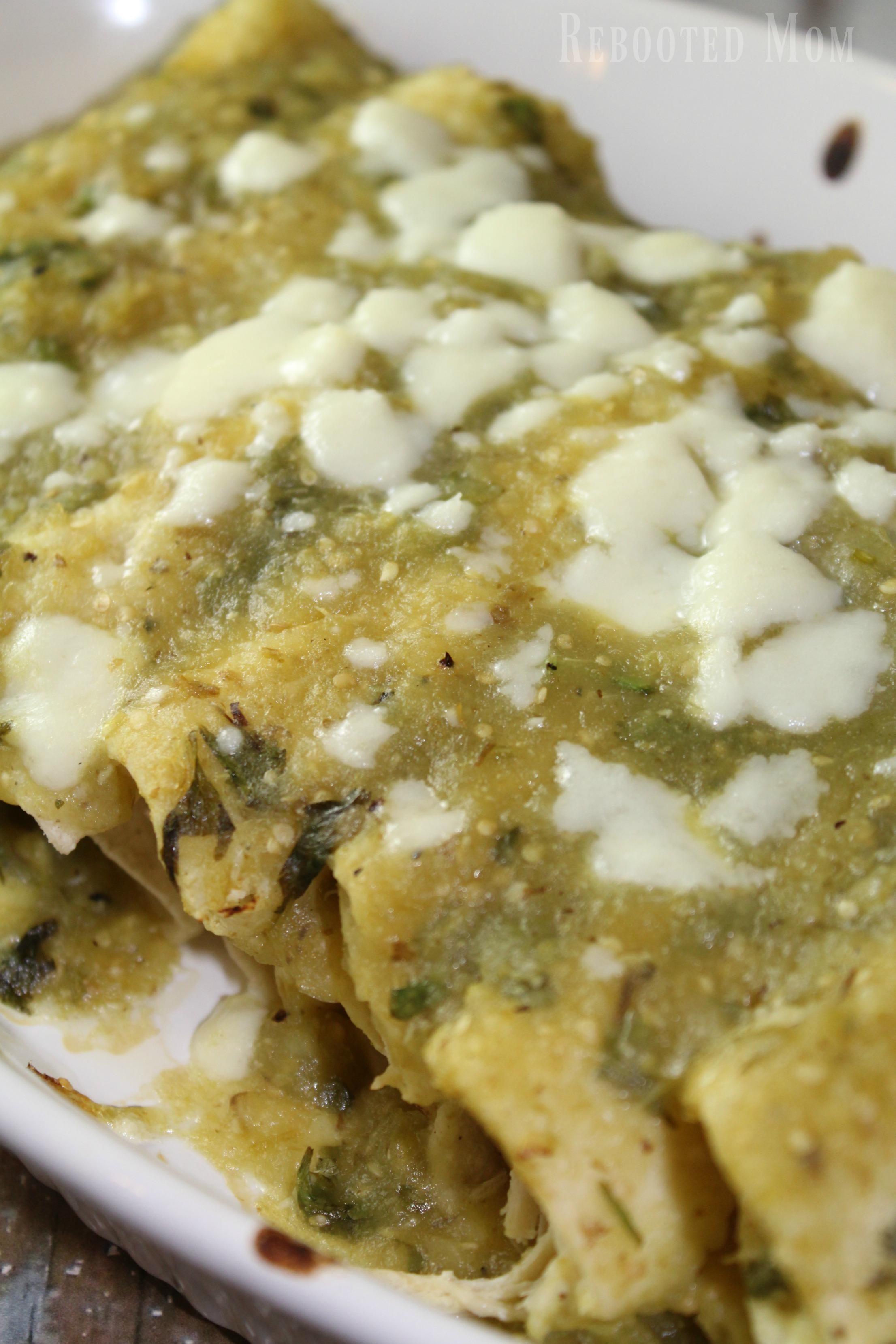 These roasted tomatillo enchiladas combine chicken enchiladas with fresh tomatillos, serrano chiles, garlic and onion blended to create a rich, green sauce that'll be your new weeknight go-to meal.