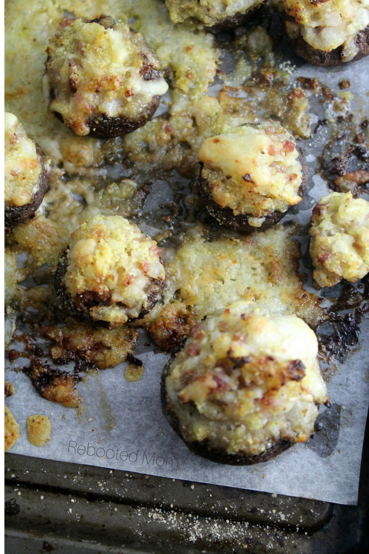 Cremini mushrooms are stuffed with a buttery filling, topped with parmesan and baked to perfection! They are the perfect appetizer! #mushrooms #appetizer #creminimushrooms 
