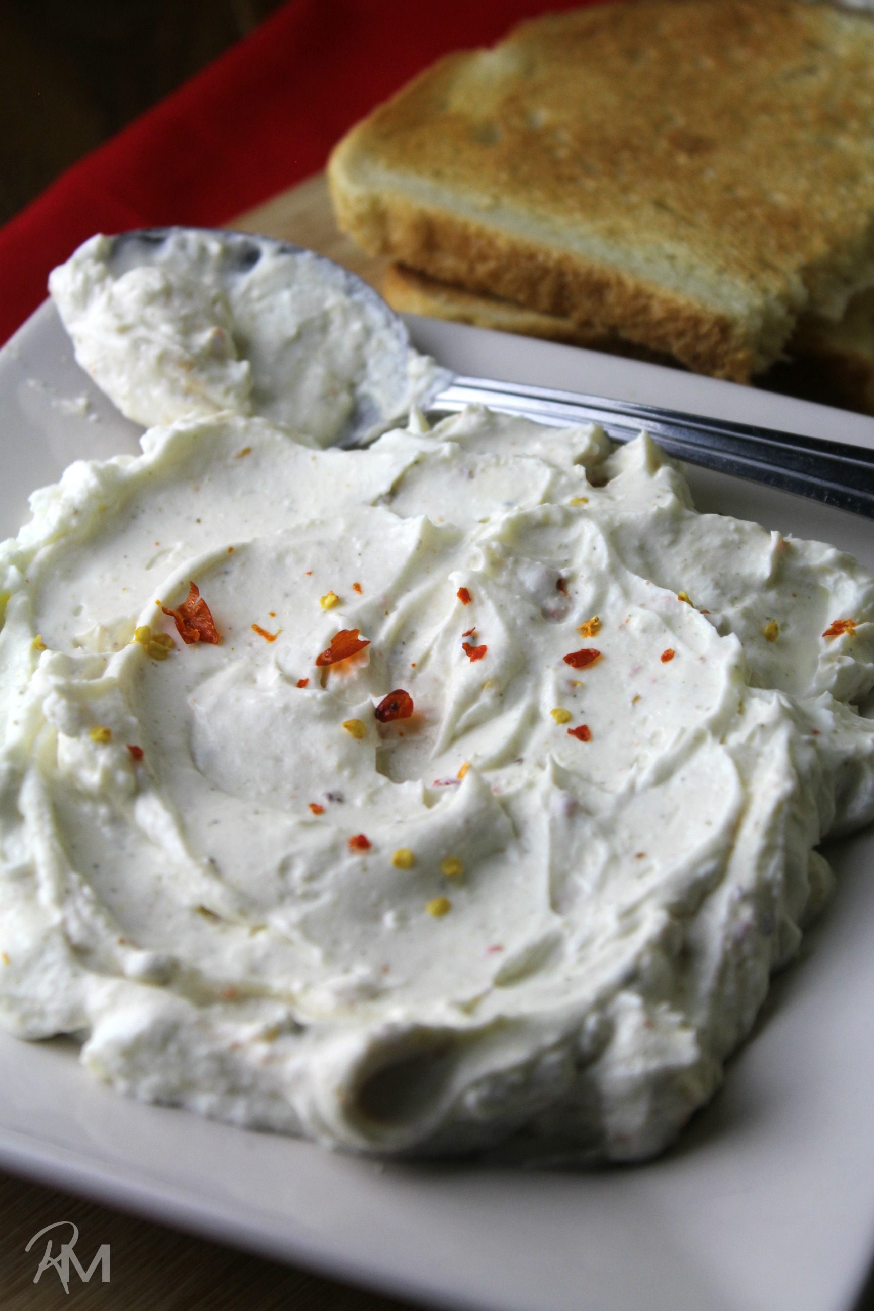 A simple yogurt cheese that includes spicy chiltepin, herbs and salt that is perfect for dipping vegetables or smearing on toasted bread.