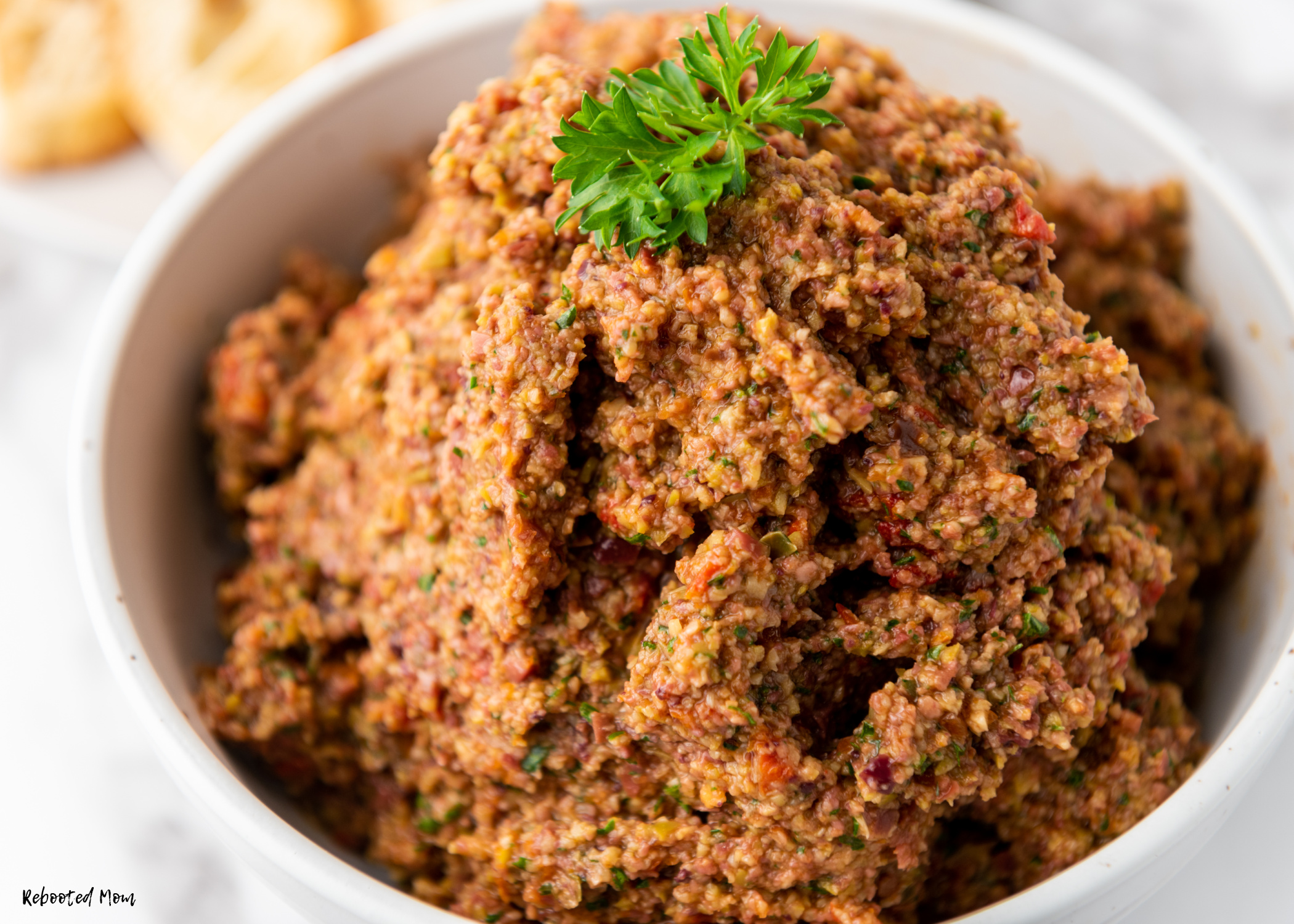 Homemade Olive Tapenade is a wonderful olive spread that is easy to make at home. Learn how to make this bold, zippy, delicious spread easily at home!
