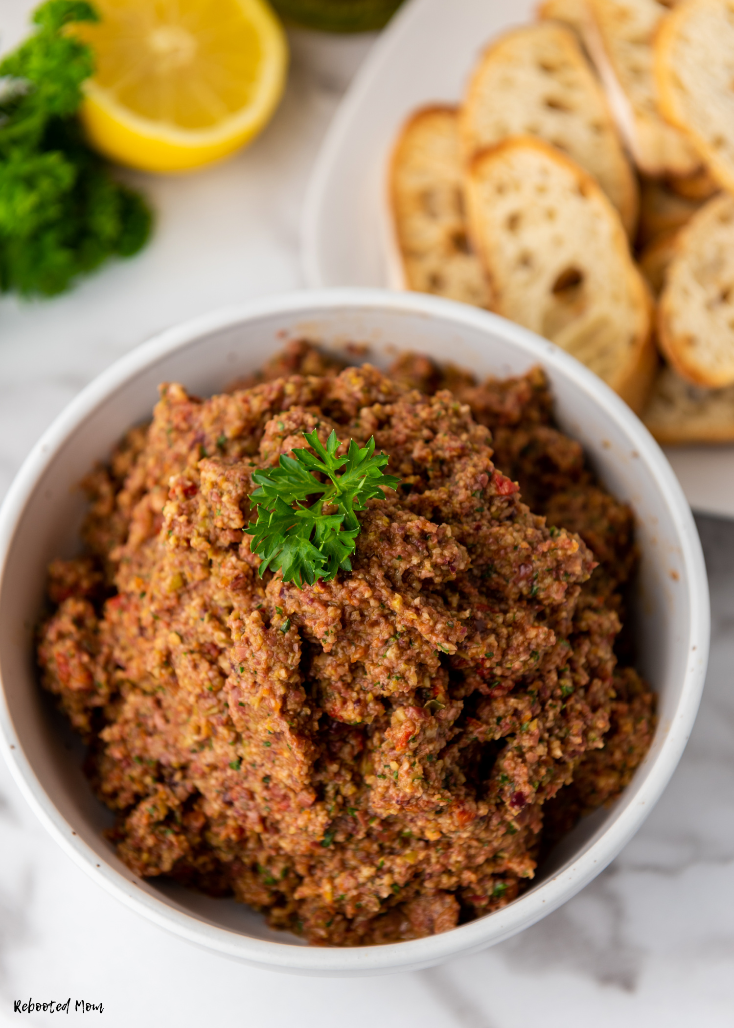 Homemade Olive Tapenade is a wonderful olive spread that is easy to make at home. Learn how to make this bold, zippy, delicious spread easily at home!